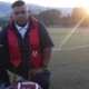 SOU Graduate Spotlight Jose Angel Stephen-Herman kneeling on football field at Southern Oregon University Learn More